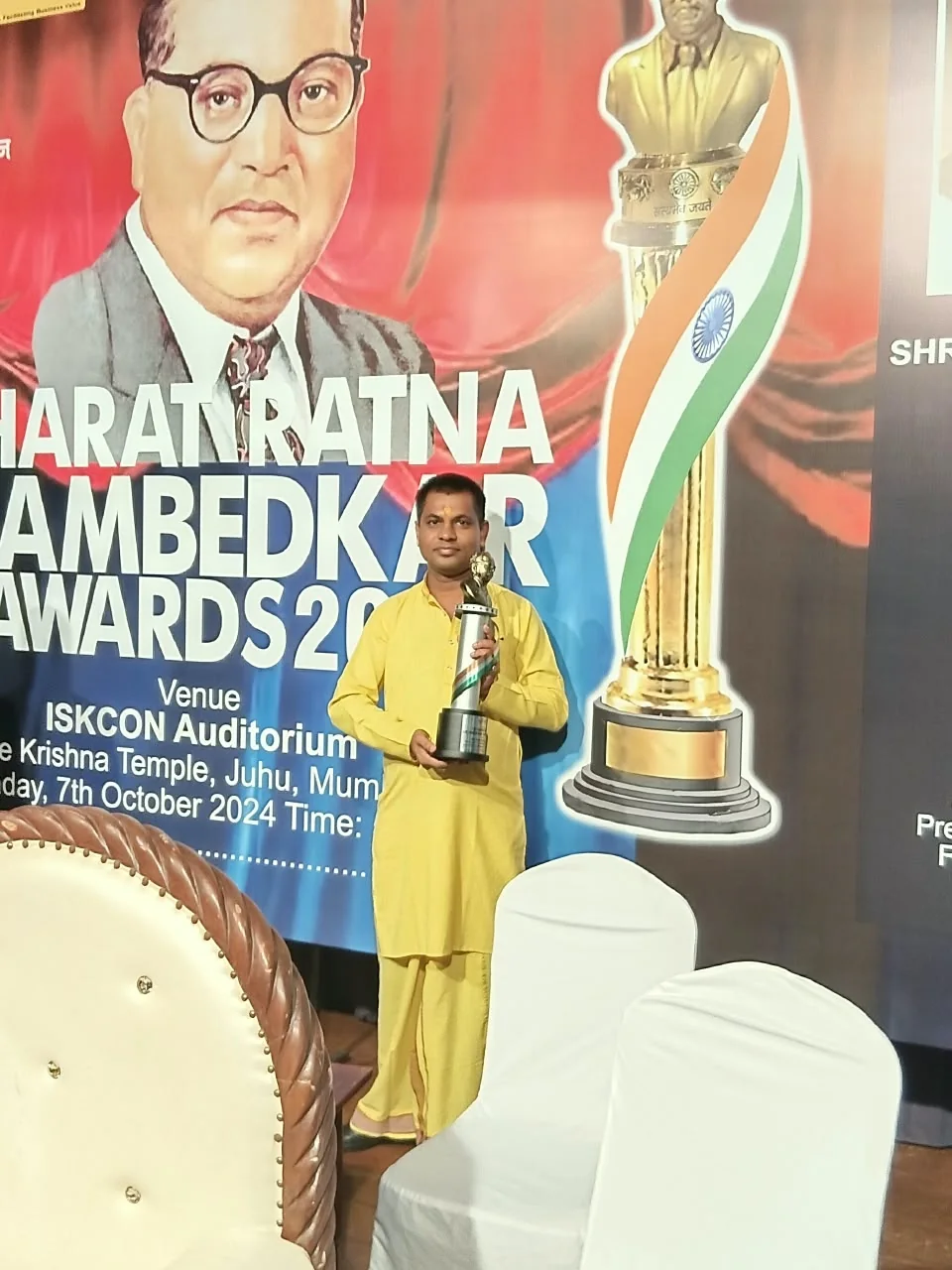 Dr. Shastri holding a trophy at the Bharat Ratna Ambedkar Awards event