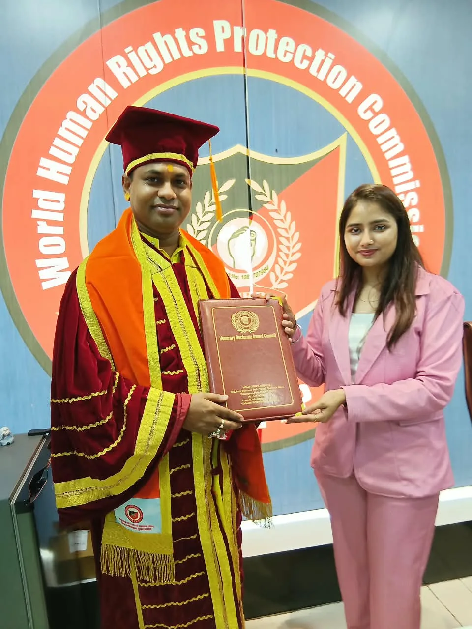 Dr. Shastri receiving a presentation at an event